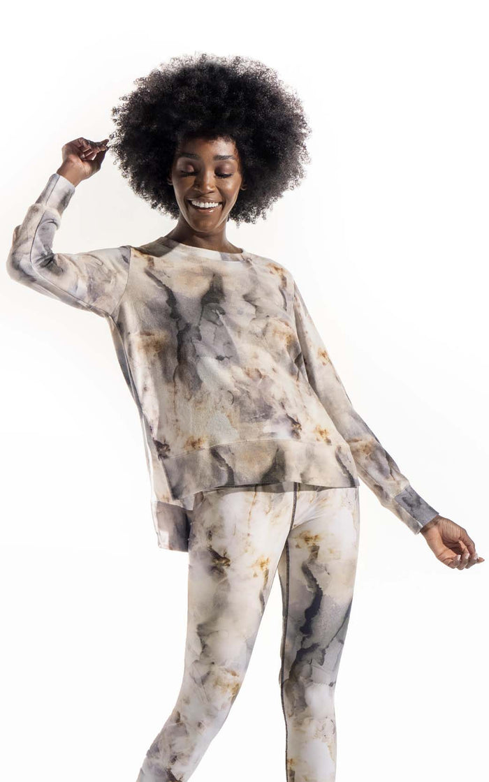 Women's long sleeve tie dye printed sweatshirt. Crew neck with high side slits and hi-lo styling. Made from blended fabric that feels like "cashmere". Made in Los Angeles